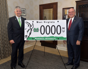 Marshall University Executive Director of Alumni Relations and Interim President Gary G. White unveil the university’s new, official West Virginia specialty license plate. The plate can be ordered through the Office of Alumni Relations.