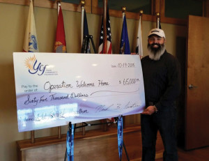 The $65,000 check presented to Operation Welcome Home. 