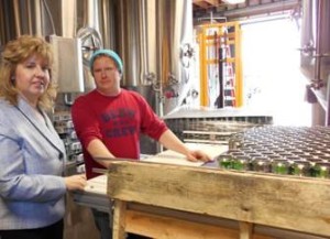Kwasniewski walks SBA District Director Karen Friel through the brewing process