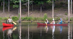 Quest leader Jonathan Bassin instructs, from left, Kelsey, Susan and Ken Cockerham of Parkersburg on basic canoe paddling strokes at North Bend Lake. Photo by Rick Steelhammer.