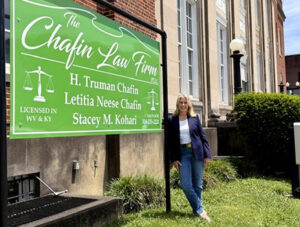 Tish Chafin stands in front of her office sign.