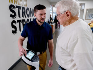 Kyle Raines, director of medical fitness, with a patient.